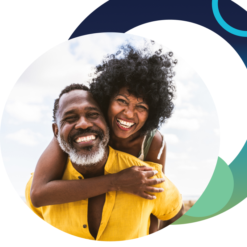 Older African-American smiling at camera. Blue circle in top right of picture and larger ombre gradient circle behind circular image of couple.